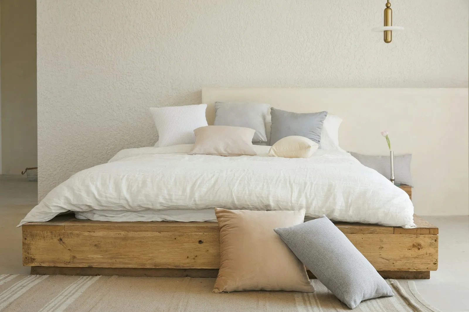 A quiet bedroom in soft early morning light with linen bedding