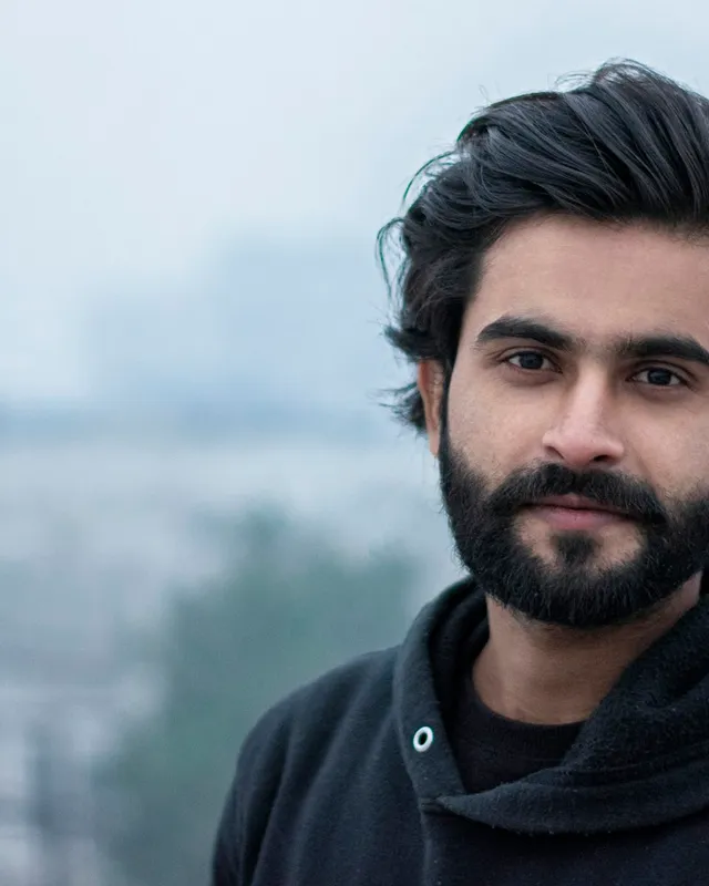 Arun Sandhu photographed in natural light against a plain background